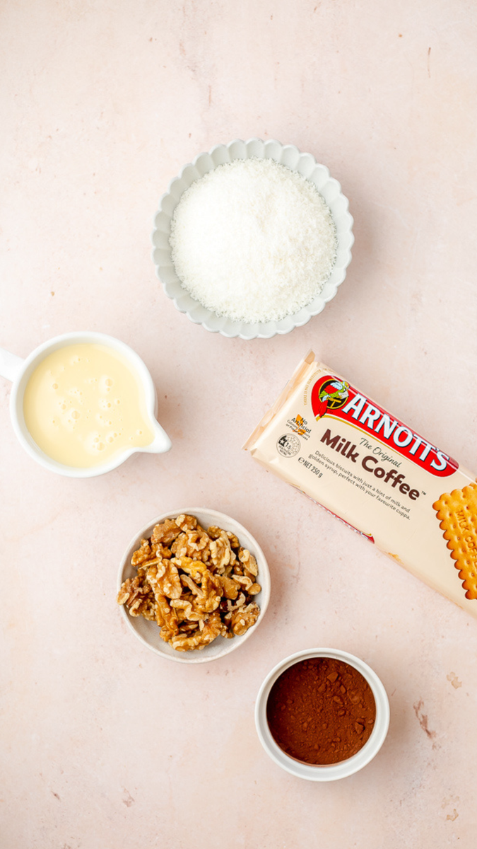 An image of walnuts, arotts milk coffee biscuits, condensed milk, cocoa powder and coconut.